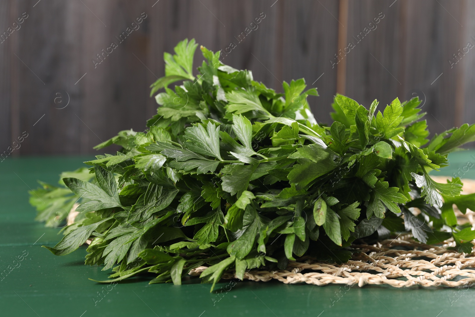 Photo of Fresh green parsley on wooden table, closeup