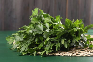 Photo of Fresh green parsley on wooden table, closeup