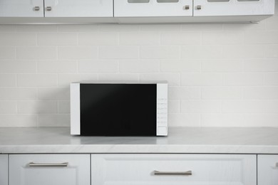 Modern microwave oven on countertop in kitchen