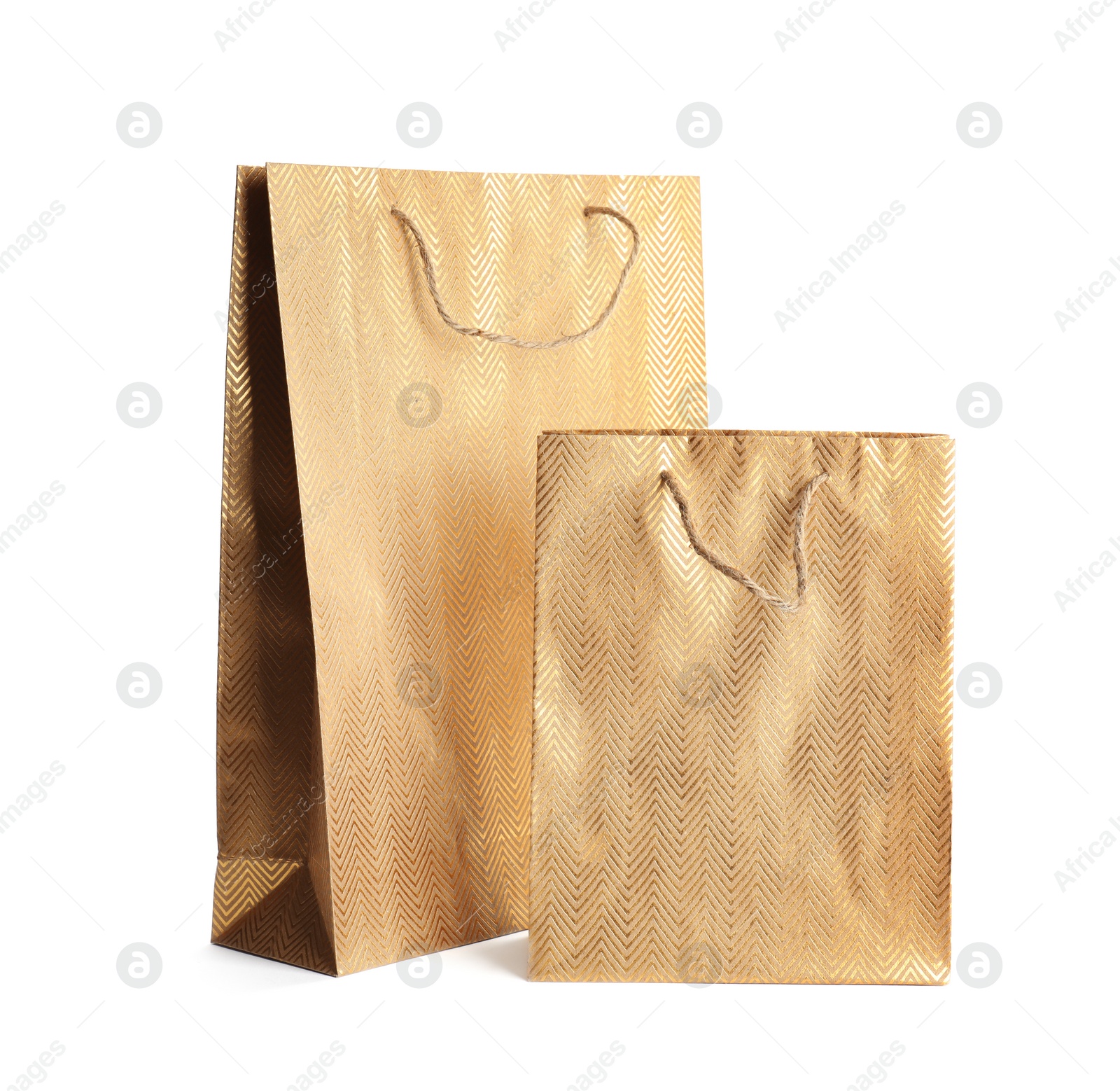 Photo of Golden paper shopping bags isolated on white. Space for design