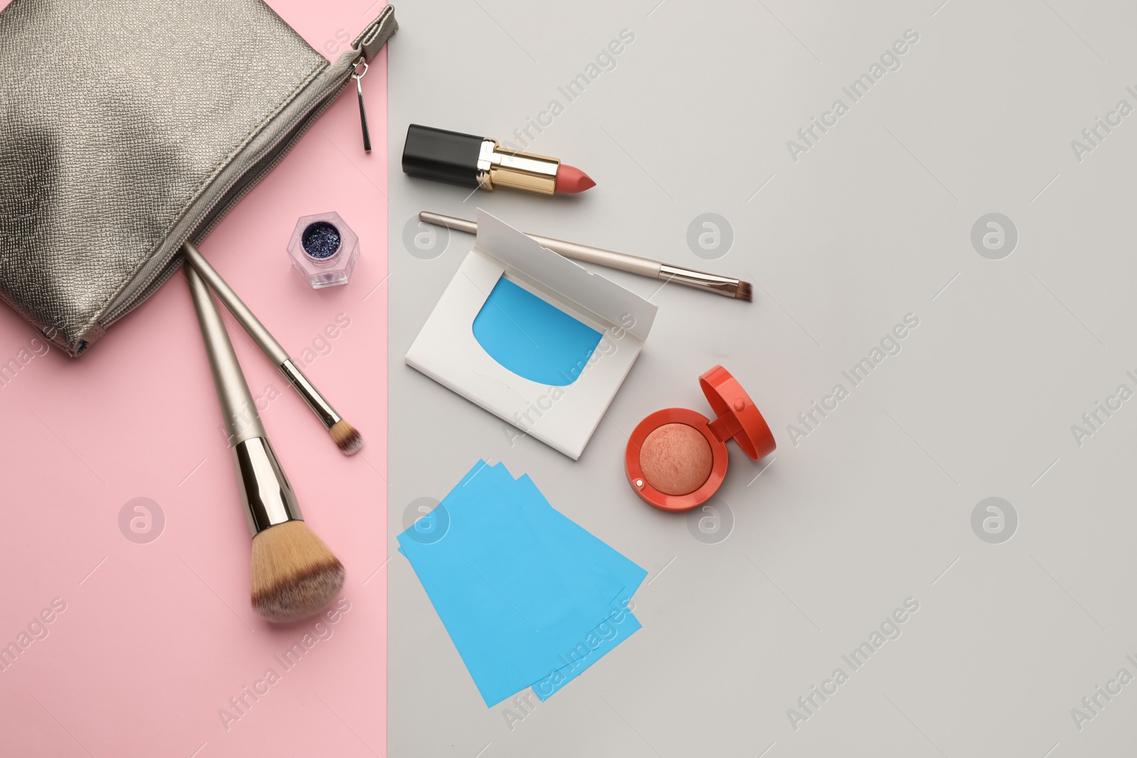 Photo of Flat lay composition with facial oil blotting tissues and makeup products on color background, space for text. Mattifying wipes