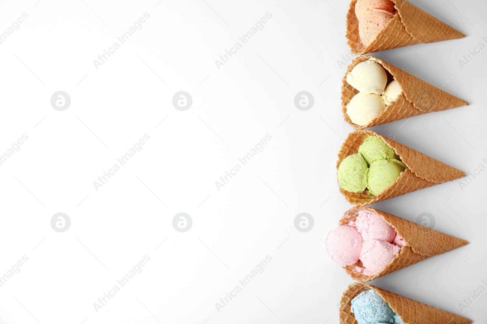 Photo of Composition with delicious ice creams in waffle cones on white background, top view