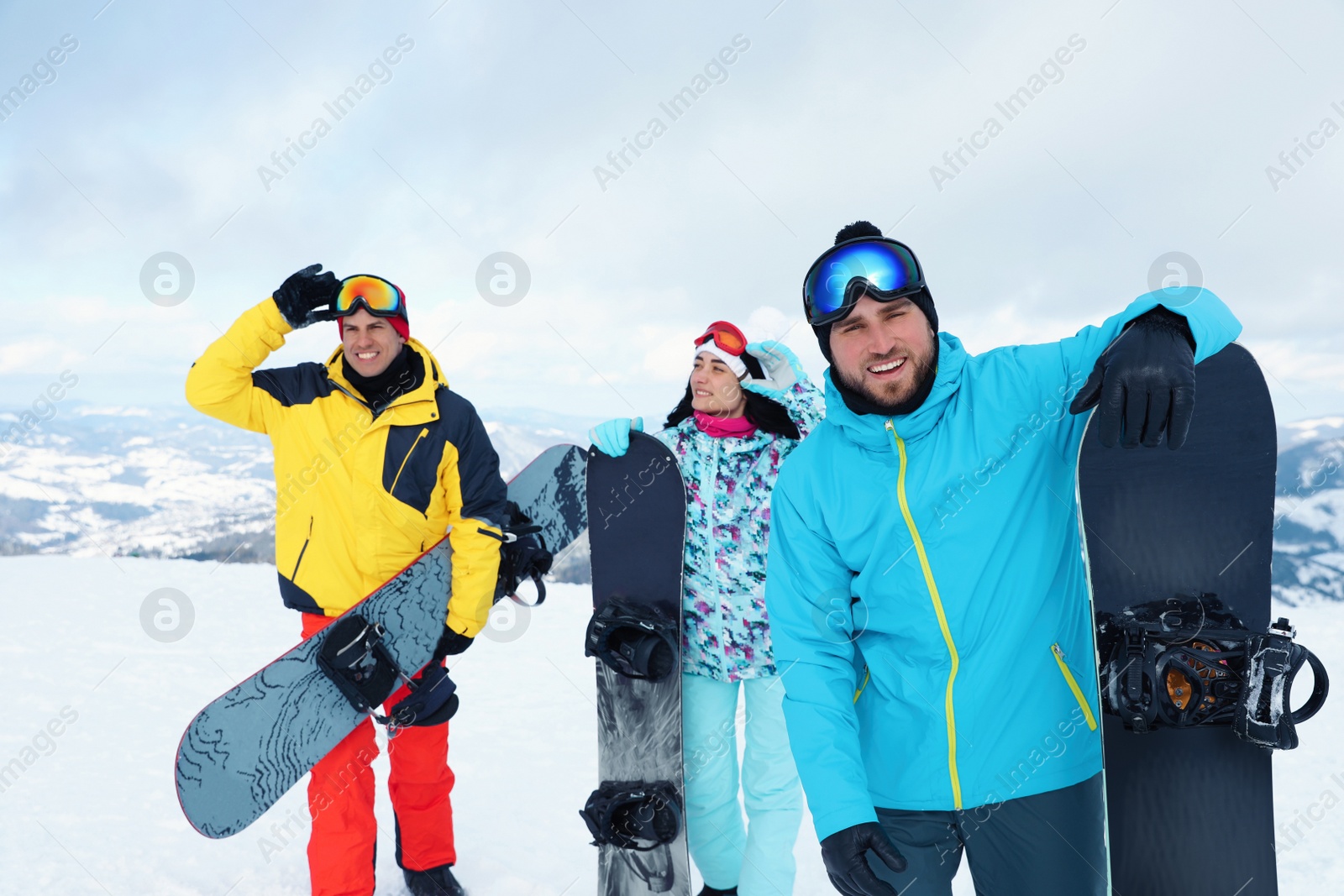 Photo of Group of friends with equipment in snowy mountains. Winter vacation