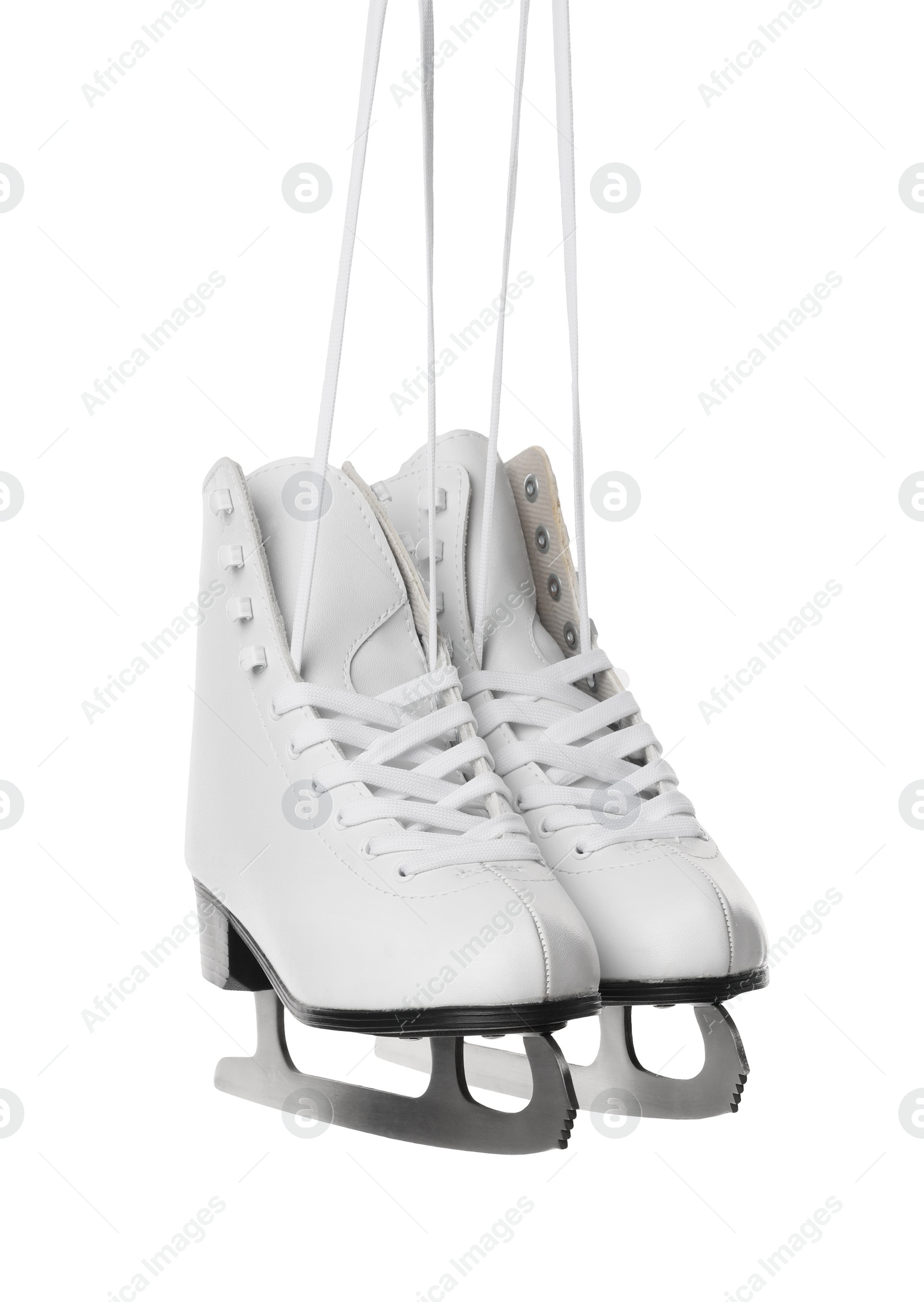 Photo of Pair of figure ice skates hanging on white background