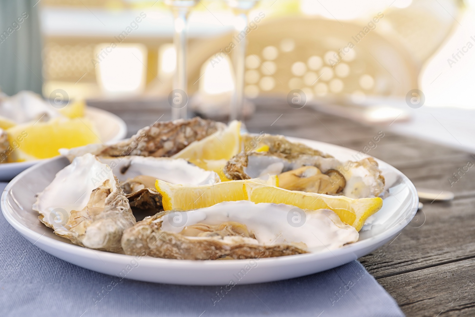 Photo of Fresh oysters with cut juicy lemon served on table