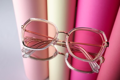Photo of Stylish sunglasses on glass table. Fashionable accessory
