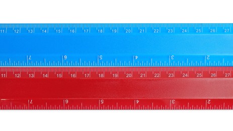 Photo of Rulers with measuring length markings in centimeters isolated on white, top view