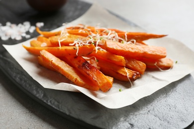 Photo of Sweet potato fries on slate board, closeup