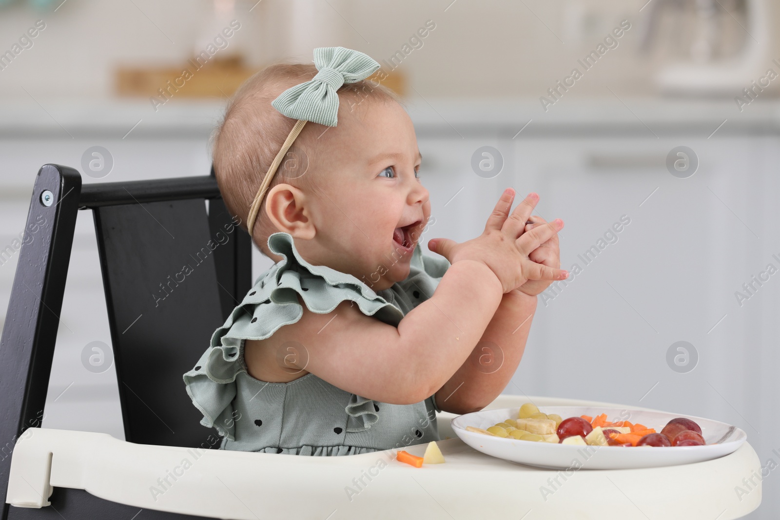 Photo of Cute little girl eating healthy food at home