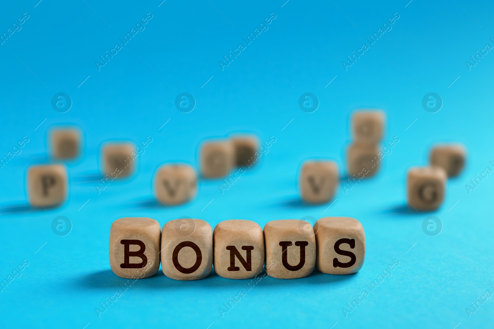 Image of Word Bonus made of wooden cubes with letters on light blue background