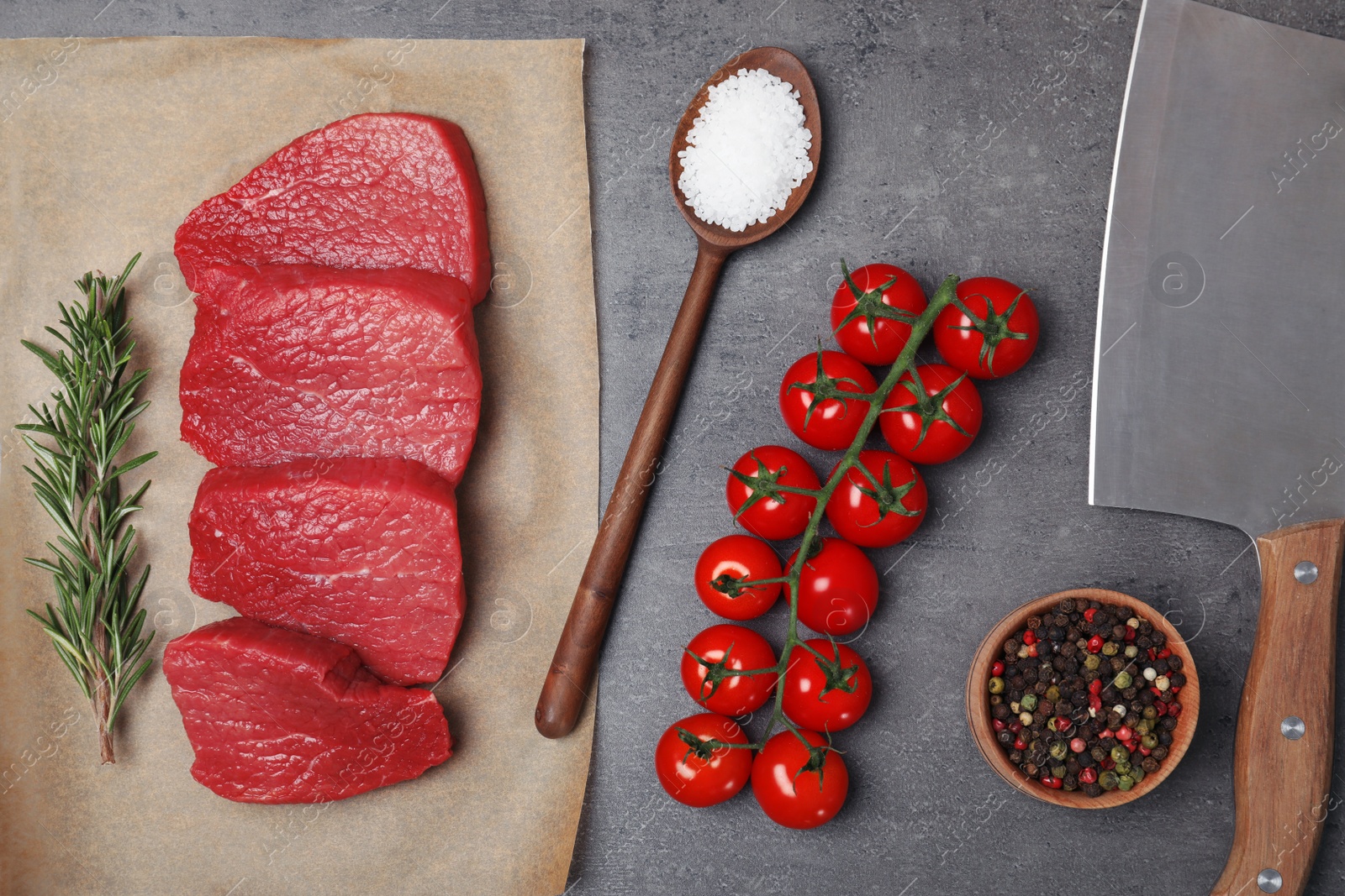 Photo of Flat lay composition with raw meat on grey background