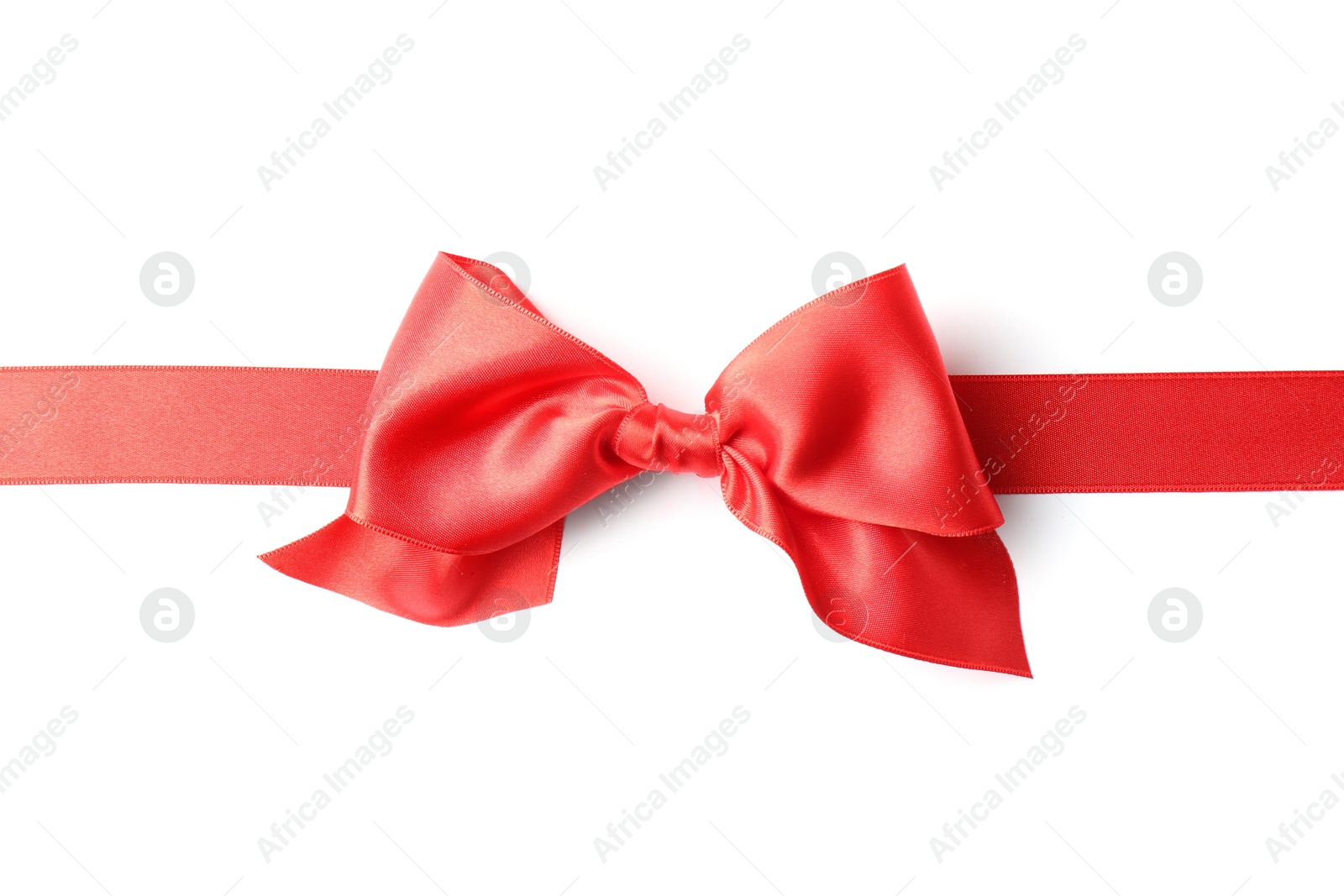 Photo of Red ribbon with bow on white background. Festive decoration