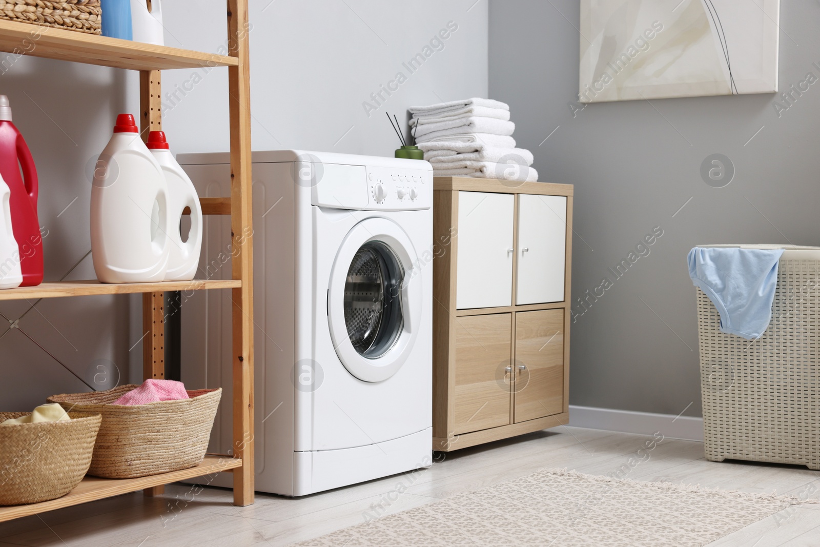 Photo of Laundry room interior with washing machine and furniture