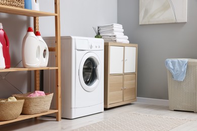 Laundry room interior with washing machine and furniture