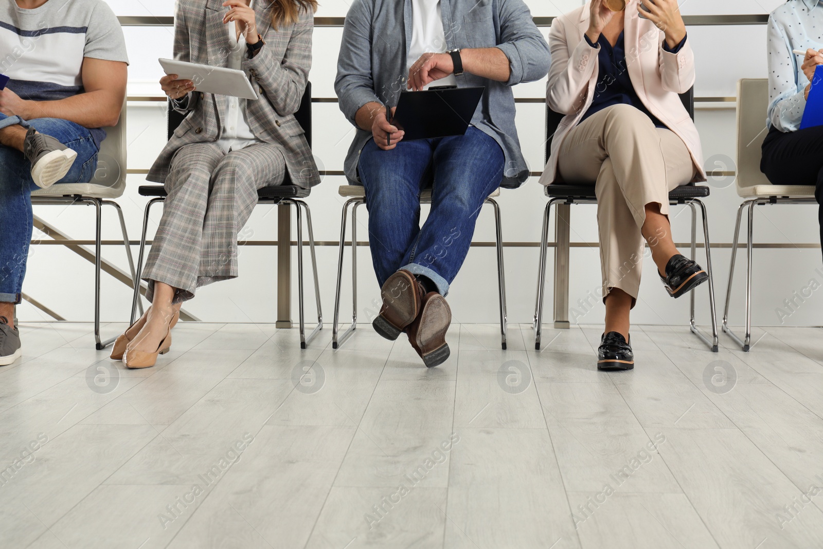 Photo of People waiting for job interview in office, closeup