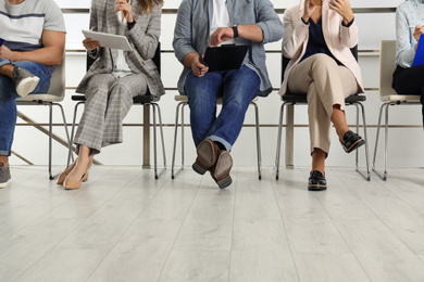 People waiting for job interview in office, closeup