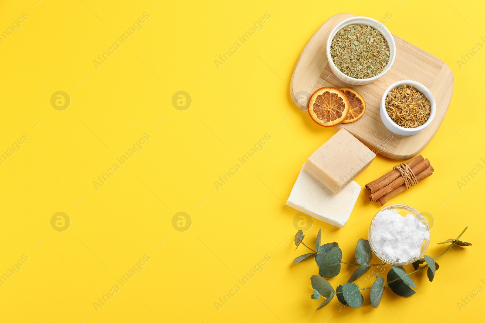 Photo of Flat lay composition with natural handmade soap and ingredients on yellow background. Space for text