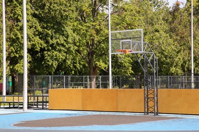 Photo of Empty basketball court with backboard outdoors on sunny day