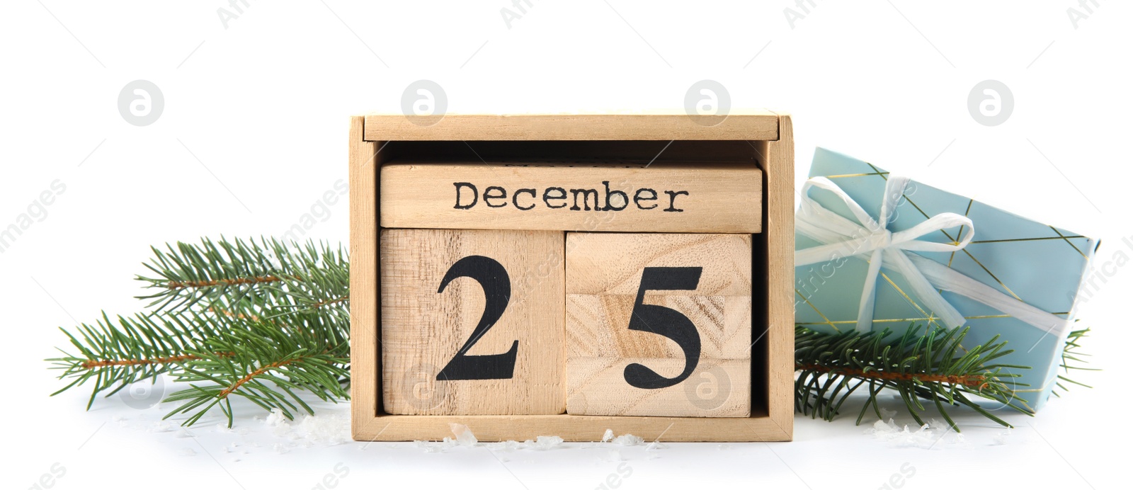 Photo of Wooden block calendar, fir branches and gift box on white background