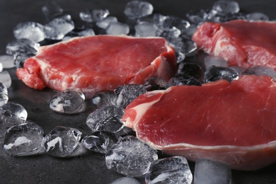 Raw meat and ice cubes on table