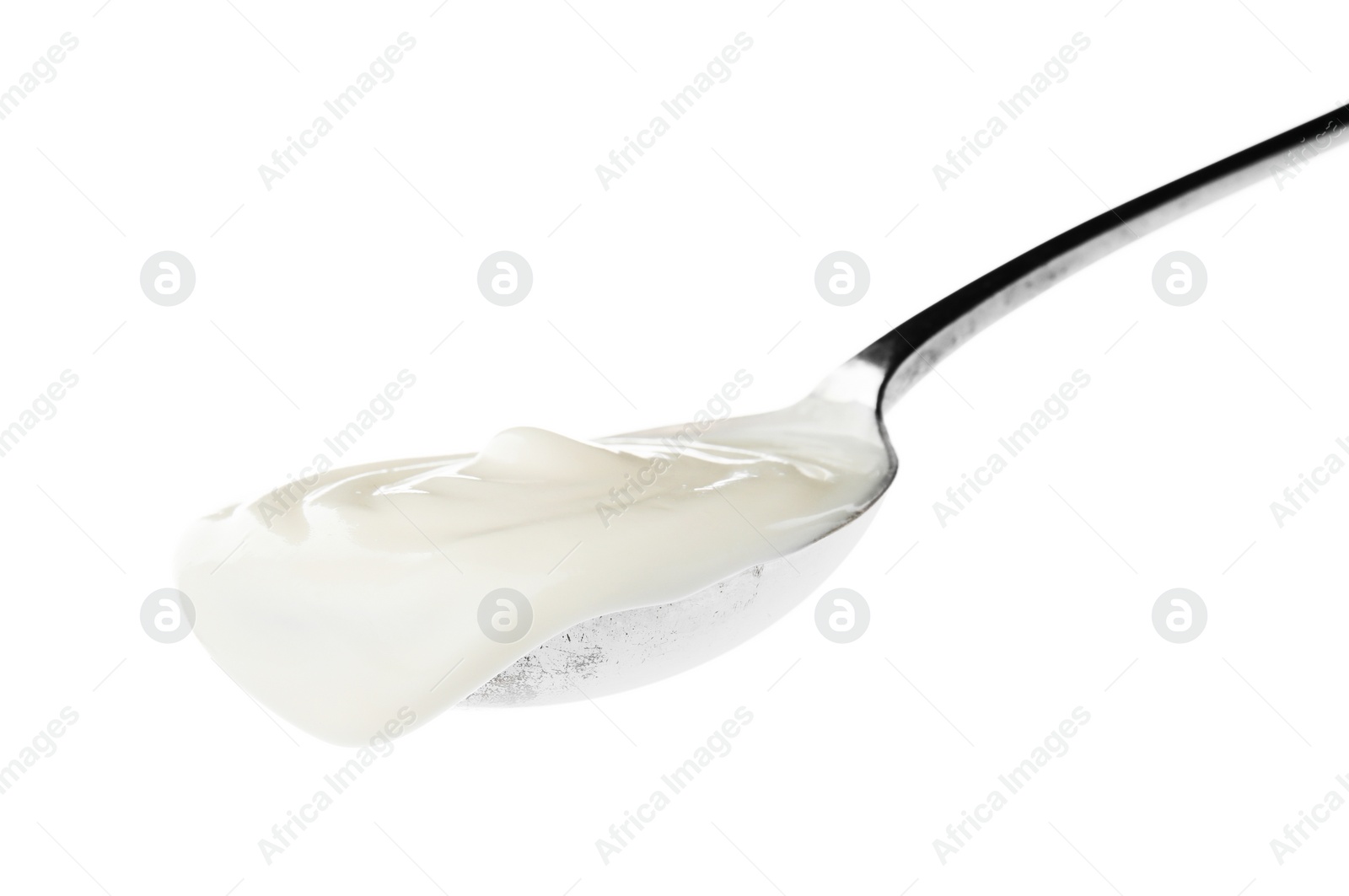 Photo of Metal spoon with sour cream on white background