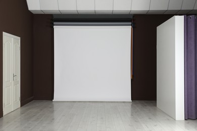 Photo of Empty white photo background. Professional studio equipment