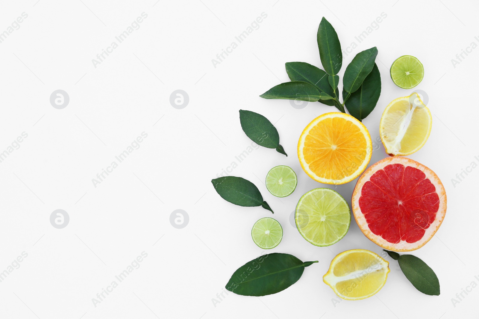 Photo of Different citrus fruits and leaves on white background, top view