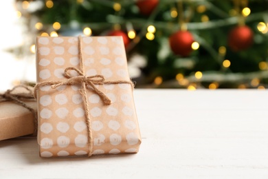 Beautiful gift boxes and blurred Christmas tree on background