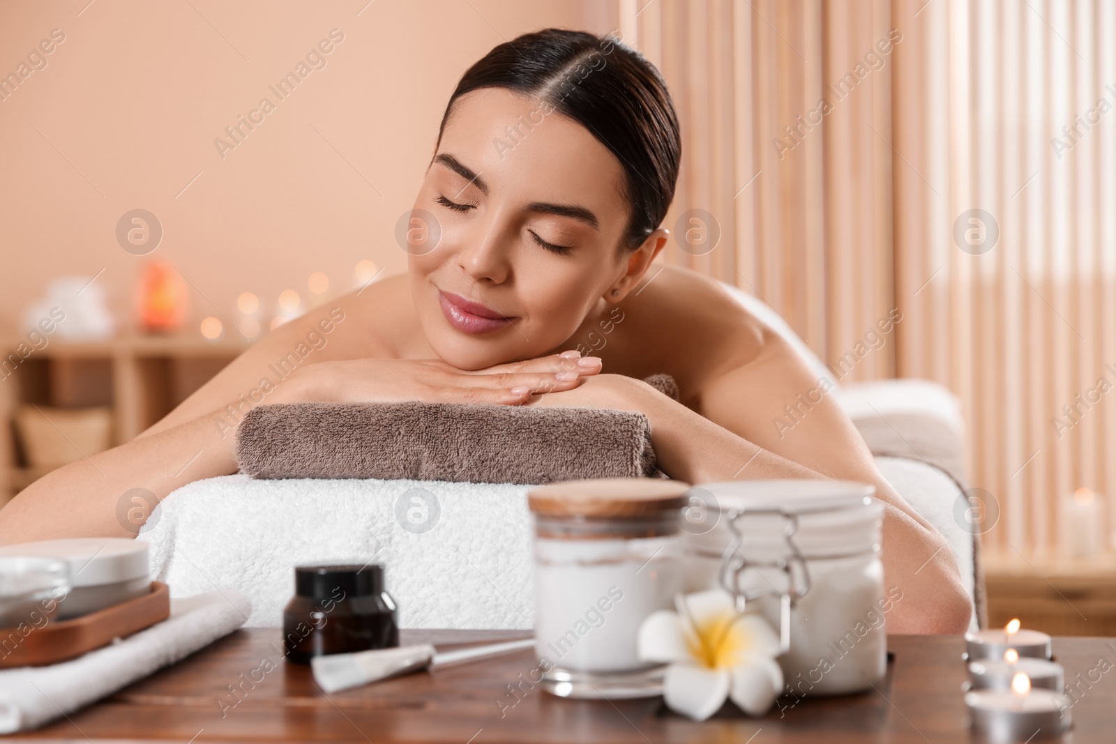 Photo of Young woman resting on massage couch in spa salon