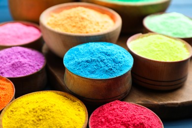 Photo of Colorful powder dyes as background, closeup. Holi festival