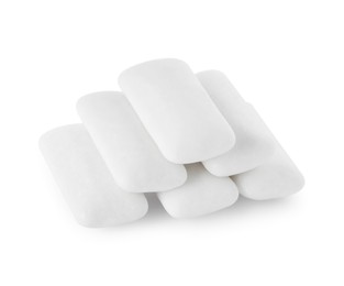 Photo of Pile of tasty chewing gums on white background