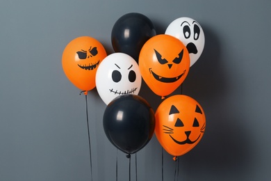 Photo of Color balloons for Halloween party on gray background