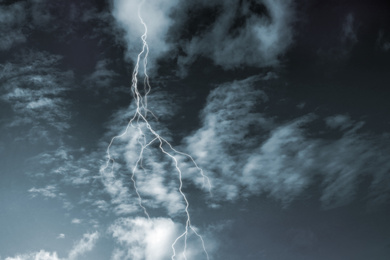 Lightning in sky covered with rainy clouds. Stormy weather