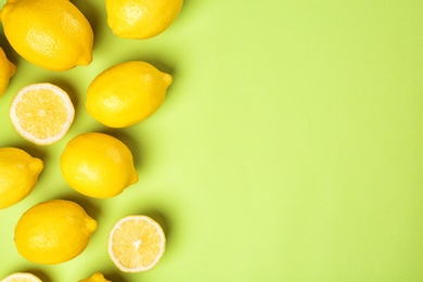 Photo of Flat lay composition with whole and sliced lemons on color background