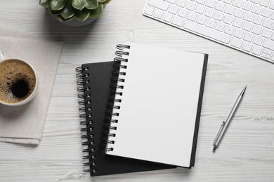 Photo of Flat lay composition with stylish notebooks on white wooden table