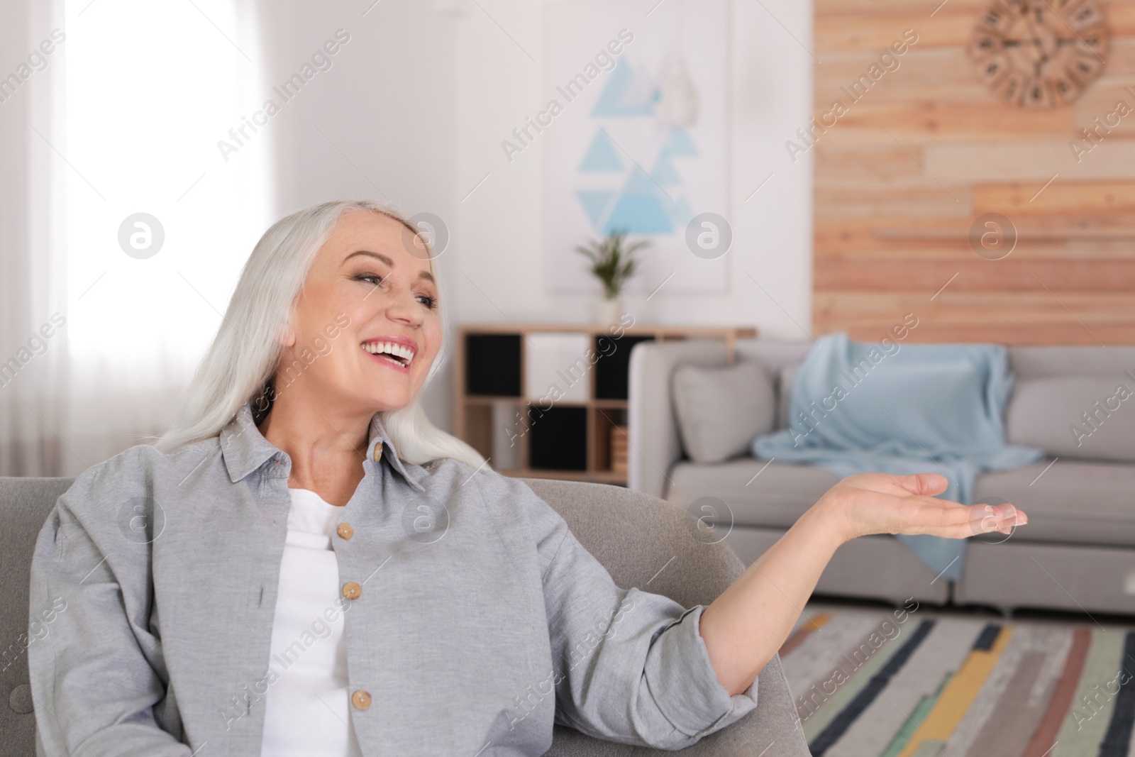 Photo of Portrait of mature woman in living room