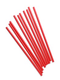 Photo of Red paper cocktail straws on white background, top view