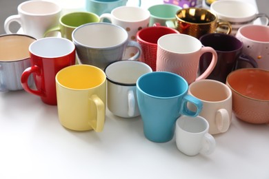 Photo of Many different cups on white background. Diversity concept
