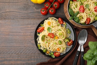 Photo of Flat lay composition with delicious pasta primavera on wooden table. Space for text