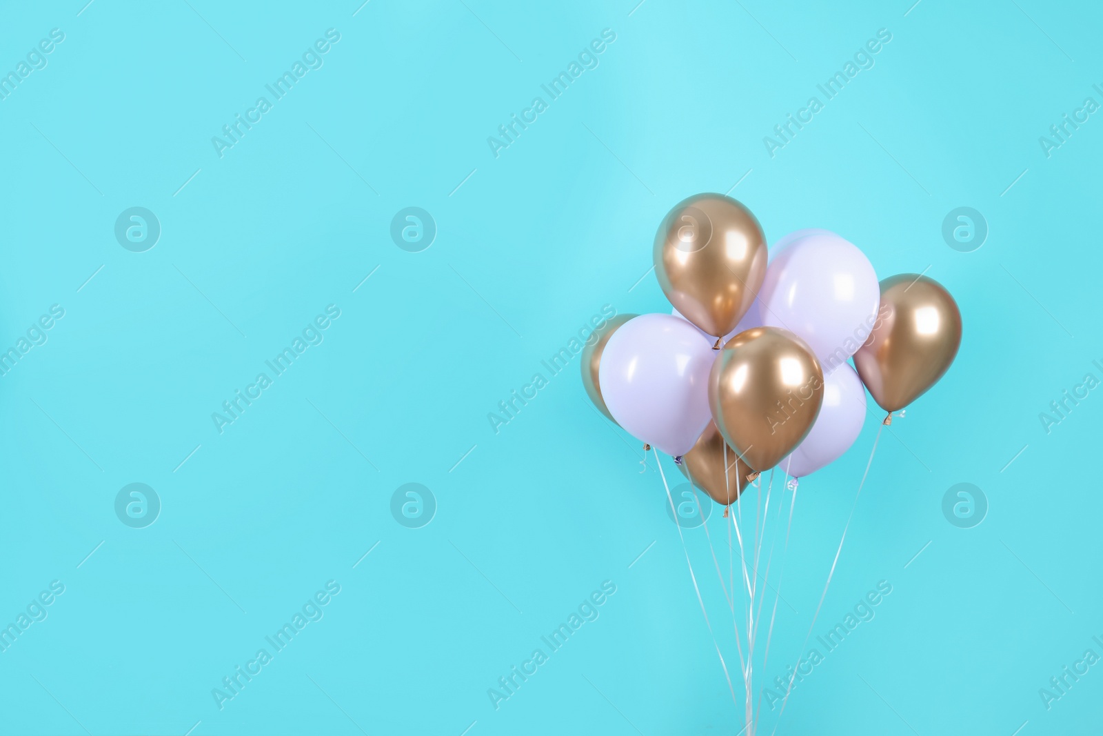 Photo of Colorful party balloons on blue background. Space for text