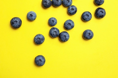 Flat lay composition with tasty blueberry on color background