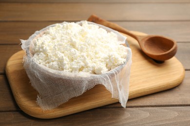 Photo of Delicious fresh cottage cheese on wooden table
