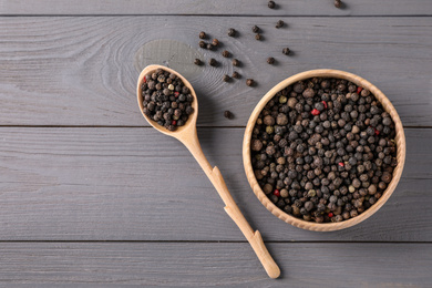 Different peppers mix on light grey wooden table, flat lay