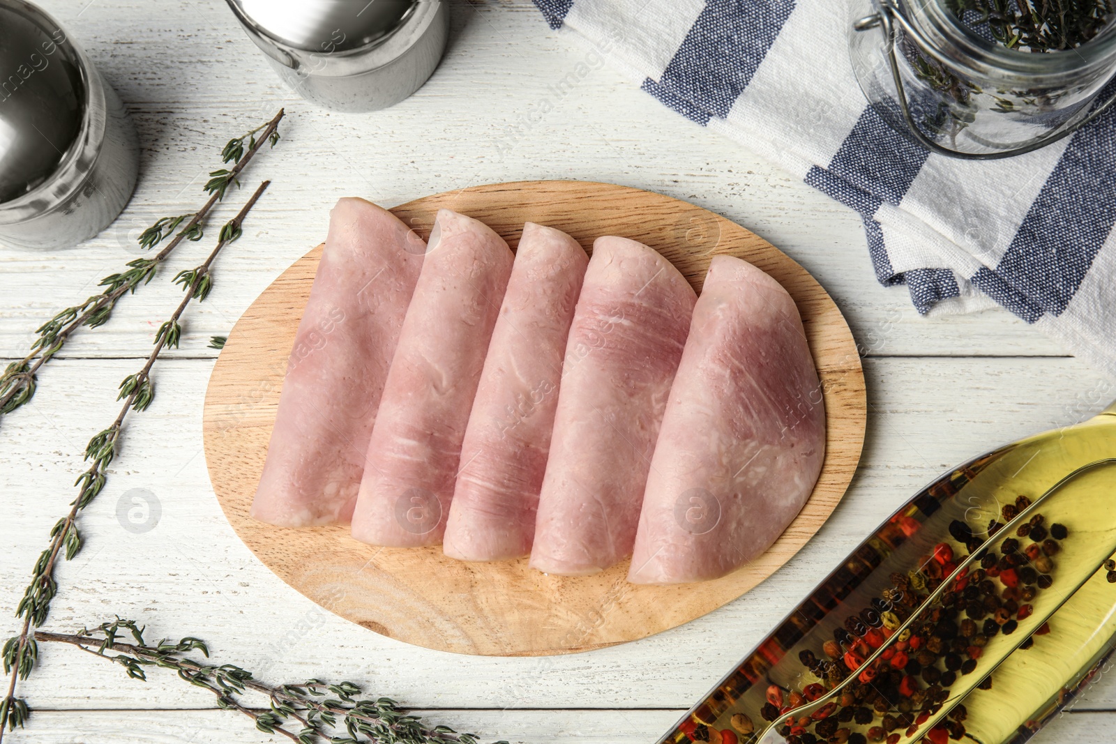 Photo of Tasty ham served on white wooden table, flat lay