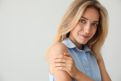 Portrait of beautiful young woman on light background