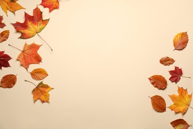 Photo of Beautiful autumn leaves on beige background, flat lay. Space for text