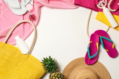 Photo of Flat lay composition with beach accessories on white background. Space for text