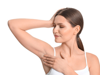 Photo of Young beautiful woman showing armpit with smooth clean skin on white background