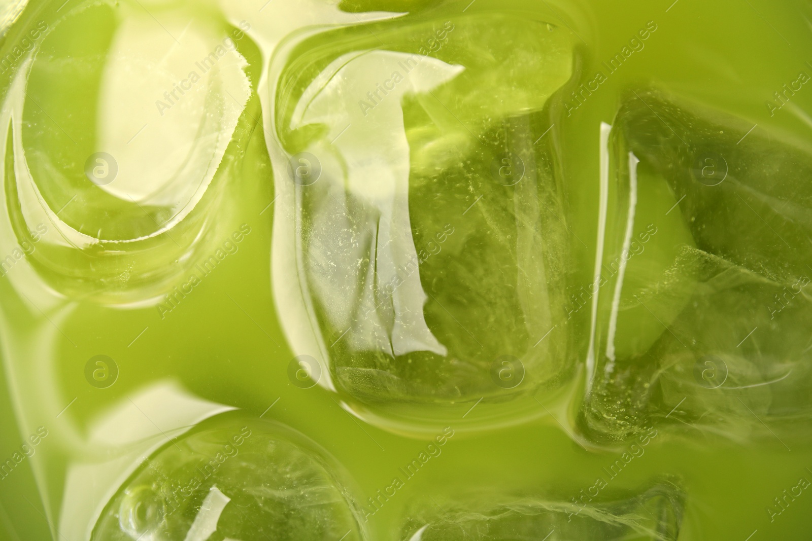 Photo of Delicious iced green matcha tea as background, closeup