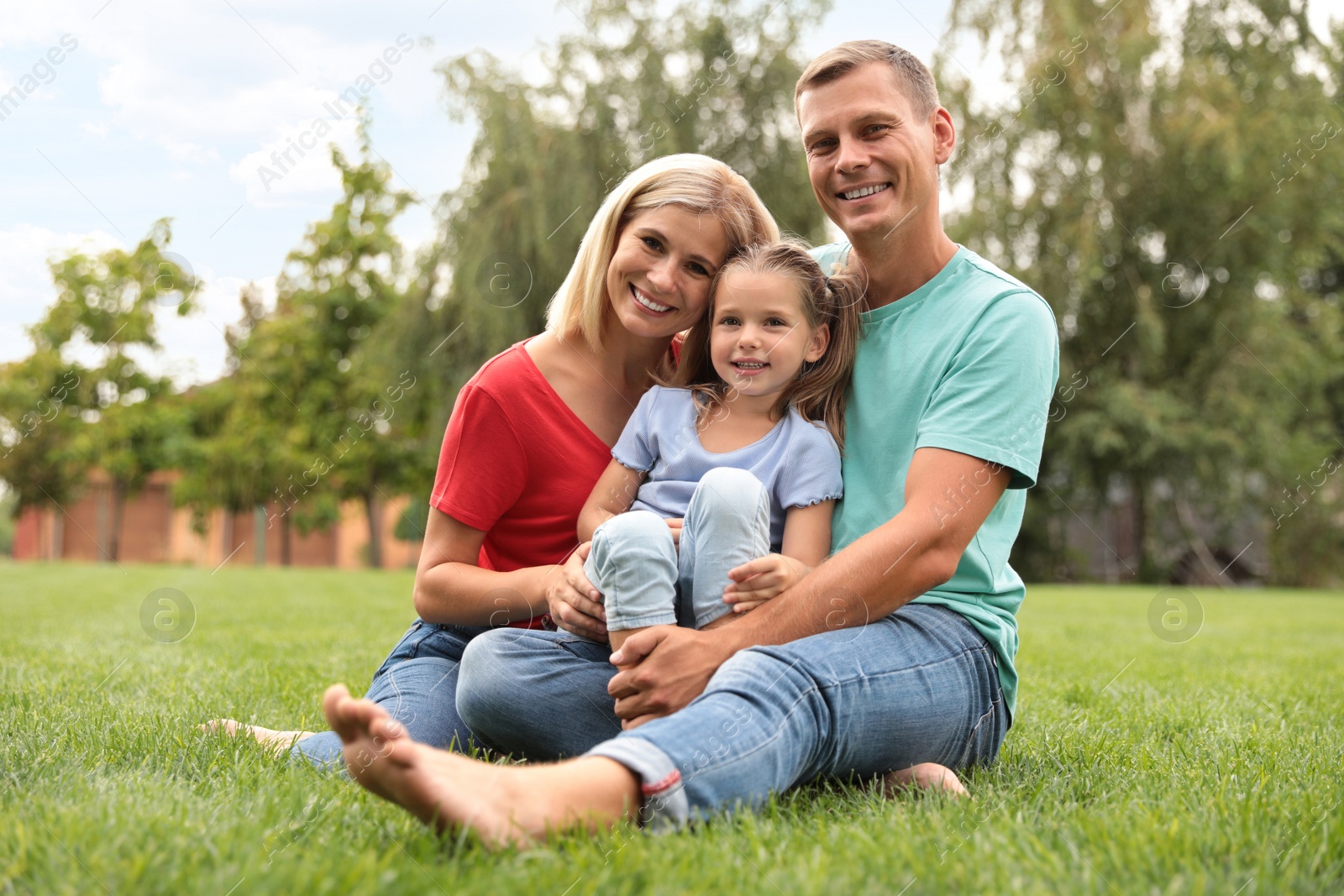 Photo of Happy family spending time together in park on sunny summer day